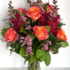 A passionate mix of flirty pink and orange free-spirit roses, striking burgundy