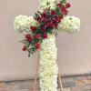 Commemorate fidelity with this standing spray cross of white blossoms adorned with
