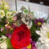 This elegant arrangement includes our most beautiful flowers and a resting Angel