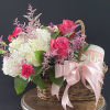 This basket of lush florals and a candle is a great gift