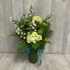 Send this petite lovely emerald themed arrangement today! Flowers and colors may