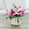 Gorgeous arrangement of Roses, Cymbidium orchids and Eucalyptus in a unique ceramic