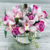 Gorgeous arrangement of Roses, Cymbidium orchids and Eucalyptus in a unique ceramic
