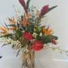 Lovely arrangement full of colorful tropicals including but not limited to birds