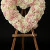 A soft and heartfelt tribute, this open-heart arrangement is crafted with delicate
