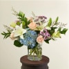 A beautiful arrangement of calming colors pairing perfectly with peach-colored flowers. Available
