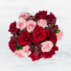 This arrangement includes purple cymbidium orchids, red roses, &amp; pink roses. Truly
