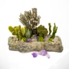 The use of a small piece of faux driftwood combined with the