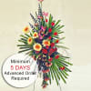 An unforgettable spray to commemorate an unforgettable life. This beautiful arrangement includes