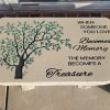 Concrete bench with green tree engraved.
