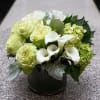 This white and green arrangement is a perfect for an office lady.