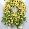 The Golden Horizon is an elegant funeral wreath, featuring yellow roses and