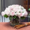 This rose arrangement is artfully designed in a large clear glass bowl.