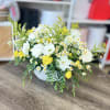 A radiant burst of sunshine in floral form, this vase arrangement features