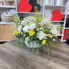 A radiant burst of sunshine in floral form, this vase arrangement features