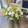 A radiant burst of sunshine in floral form, this vase arrangement features