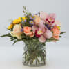 Poppy features a Pink Cymbidium Orchid bloom, Blush Pink Roses, Peach Roses