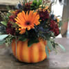 This classic fall centerpiece in a pumpkin planter is a great seasonal