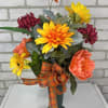 A green cone arranged with artificial sunflowers, dalilah&#039;s, peonies, and mixed greenery.