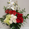 Tropical romance is a beautiful romantic arrangement with orchid, roses, hydrangea and