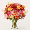 Peach roses, red alstroemeria and pink lilies are a fragrant and floral