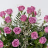 Stunning and dramatic display of 12 long-stemmed lavender roses expertly designed among