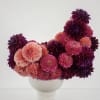 A sculptural celebration of dahlias in full splendor, this modern arrangement captivates