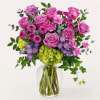 An exquisite balance of purple and green stems are masterfully arranged, creating
