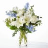 White roses, delicate delphinium, and blooming lilies come together for a luxurious