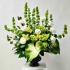 This arrangement includes Bells of Ireland, White Roses, Green Cymbidium Orchid Blooms