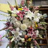 Honor a beautiful life with this radiant and full standing spray, featuring