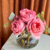 A delicate gathering of six lush garden roses arranged in a petite