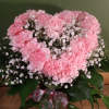 Carnations arranged a heart shape design in a color coordinating vase.
Comes in