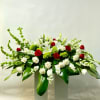 This Casket Spray Includes Bells of Ireland, White Snapdragon, White Stock, Red