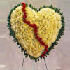 Send your heartfelt condolences with this heart-shaped standing wreath, created with the