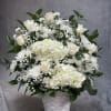  An elegant all-white display featuring lush hydrangeas, timeless roses, and soft