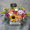 A charming white purse brimming with a joyful sunflower, vibrant carnations, and