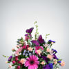 Delicate and whimsical, this charming arrangement features pink gerbers, purple carnations, soft