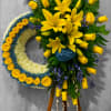 Bright and bold, this crescent-style arrangement features vibrant yellow roses and lilies