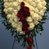 Dozens of white carnations with red roses lush green trim on a
