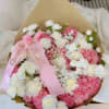 A delicate bouquet in soft pinks and whites, handcrafted with roses, carnations