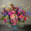 Elevate your space with our stunning floral arrangement, featuring vibrant delphiniums, luscious