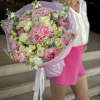 A romantic bouquet in soft pastel shades, blending lush pink hydrangeas, delicate