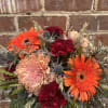 Chrysanthemums, Gerbera Daisies, and Carnations mixed with blue thistle and dried wheat