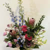 Roses, Blue Delphinium, Stock, Protea with greens in a wooden vase. Flowers