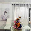 This arrangement is a bold, modern floral composition that combines vivid color