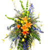 A bright bouquet of orange lilies, blue delphinium, and a lush assortment