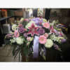 A beautiful casket spray including beautiful stargazer lilies. 