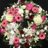 A beautiful sympathy wreath with pinks and whites. 