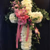 A Beautiful white cross spray with a variety of pink flowers going
